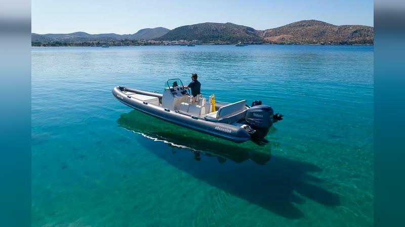 Obsession 7.40 RIB anchored near the shore in a turquoise bay