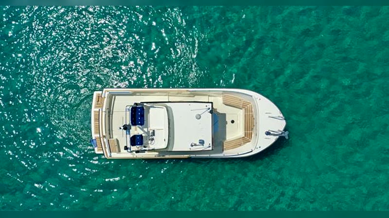 Targa 27 anchored over turquoise water, aerial view