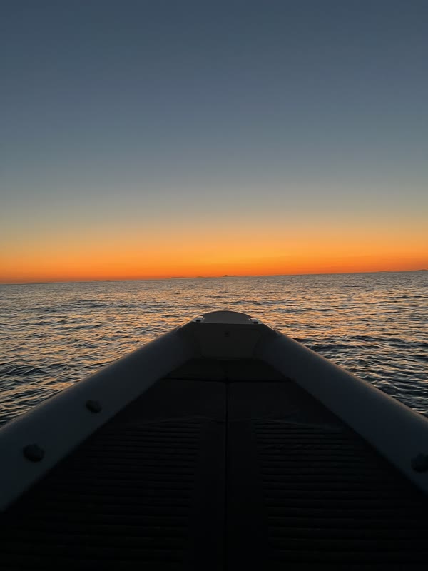 Dusk over calm water from the bow